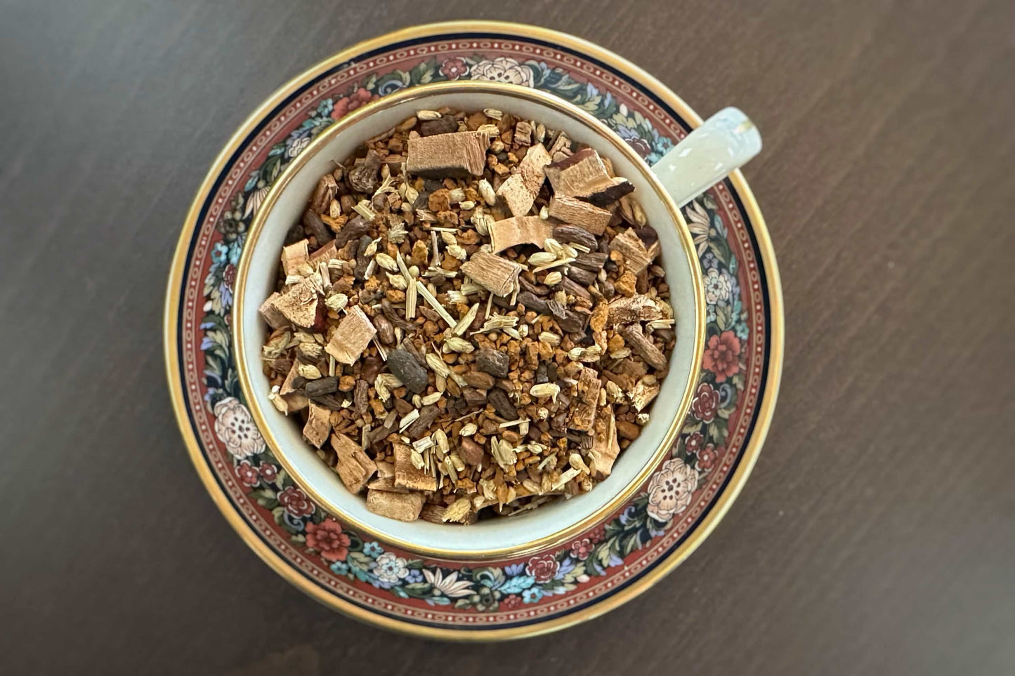 teacup full of mushroom, root and flower