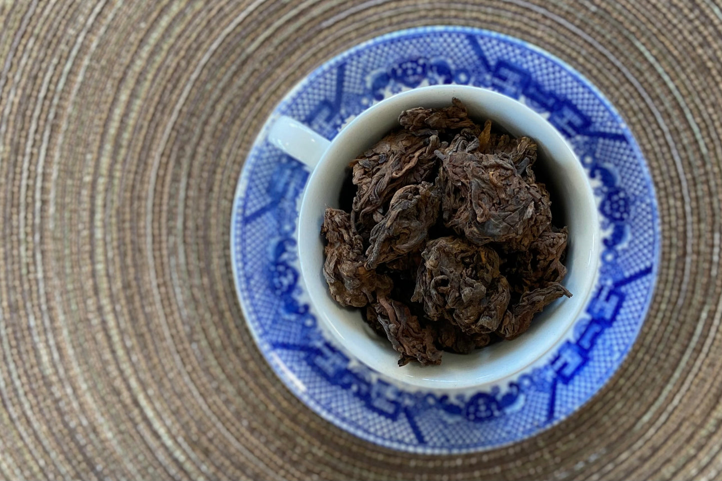 Teacup full of aged tea lumps