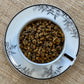Teacup full of golden rolled tea house