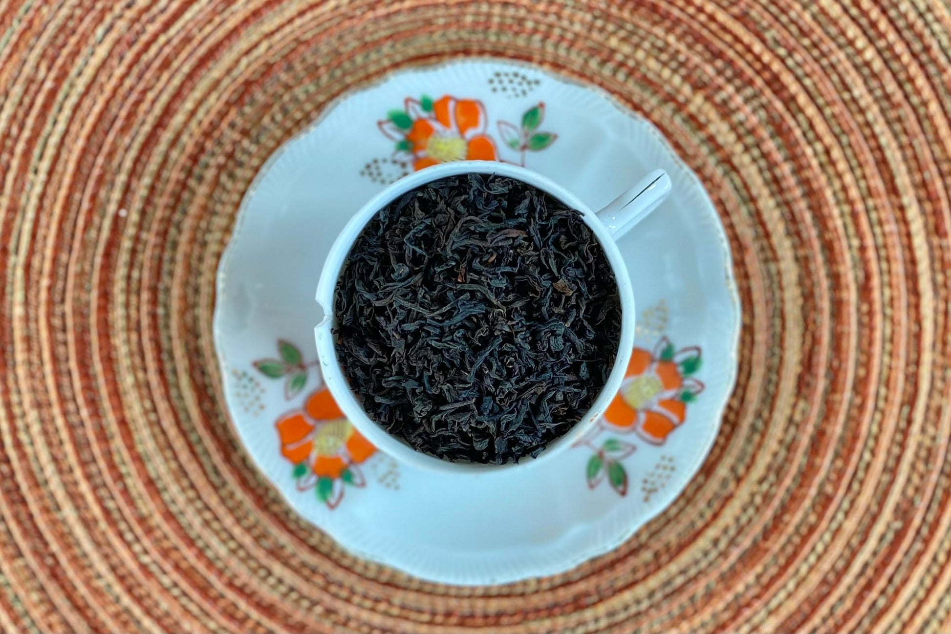 teacup full of pure black tea leaf