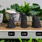 Three crow tea pets on a gongfu tray. All have matte black bodies and glittery glossy black beaks. CR1 is short and squat, CR2 is tall and thin, and CR3 is quite round.
