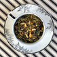 teacup full of black and white tea with citrus peel