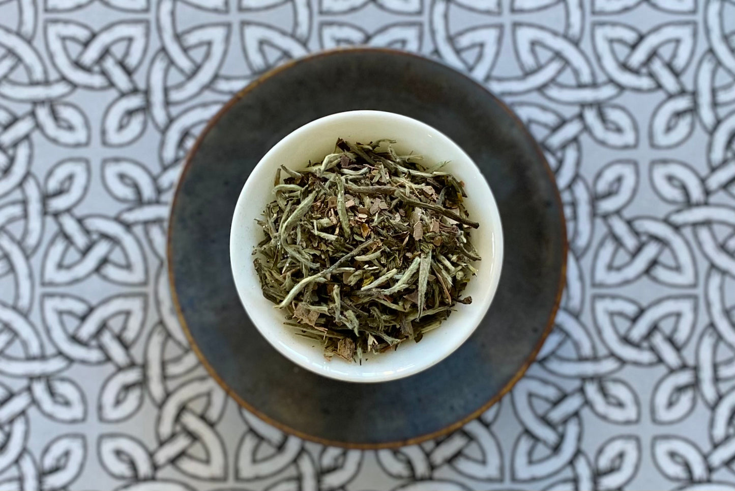 Teacup full of glittery silver white tea tips