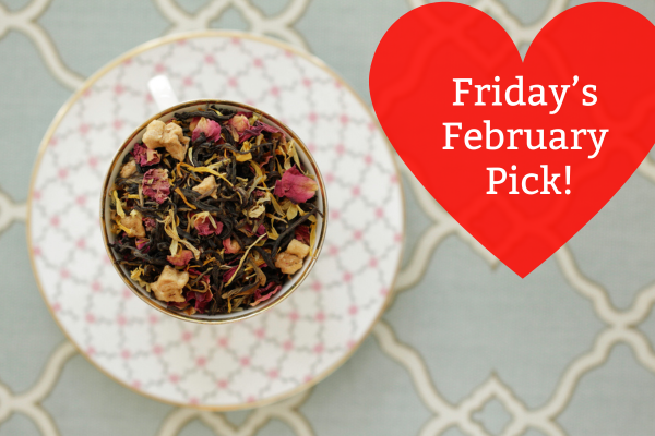 Tea leaves in a teacup on a white plate with a red heart-shaped label reading 'Friday's February Pick!'.
