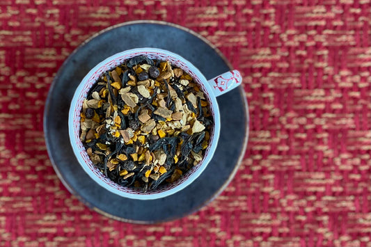 teacup full of dark oolong leaf and rich warm spices