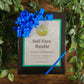 Self-care bundle with a blue ribbon on a wooden surface with green leaves