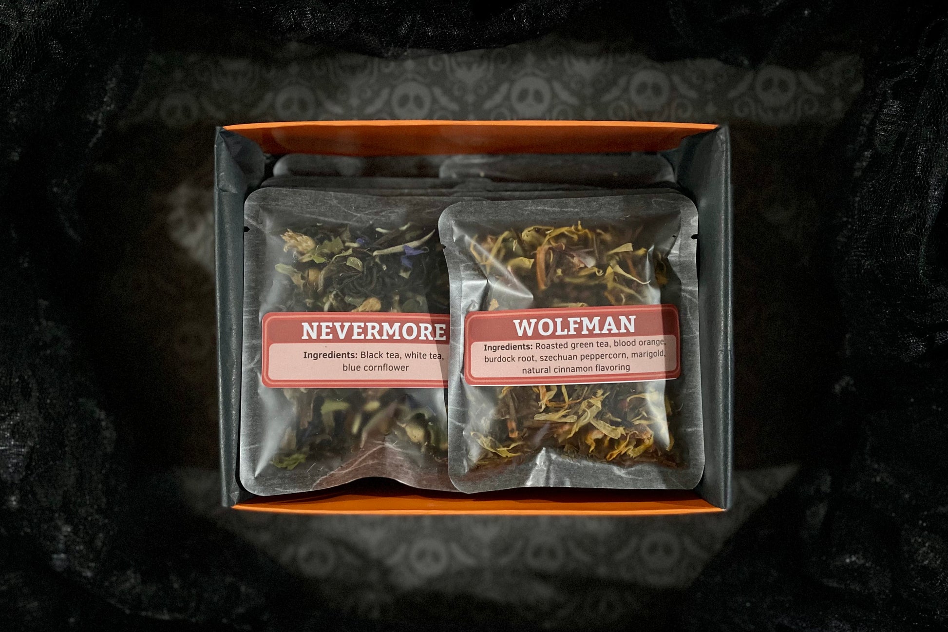 Open orange sampler box on black background with two teas showing: Nevermore & Wolfman
