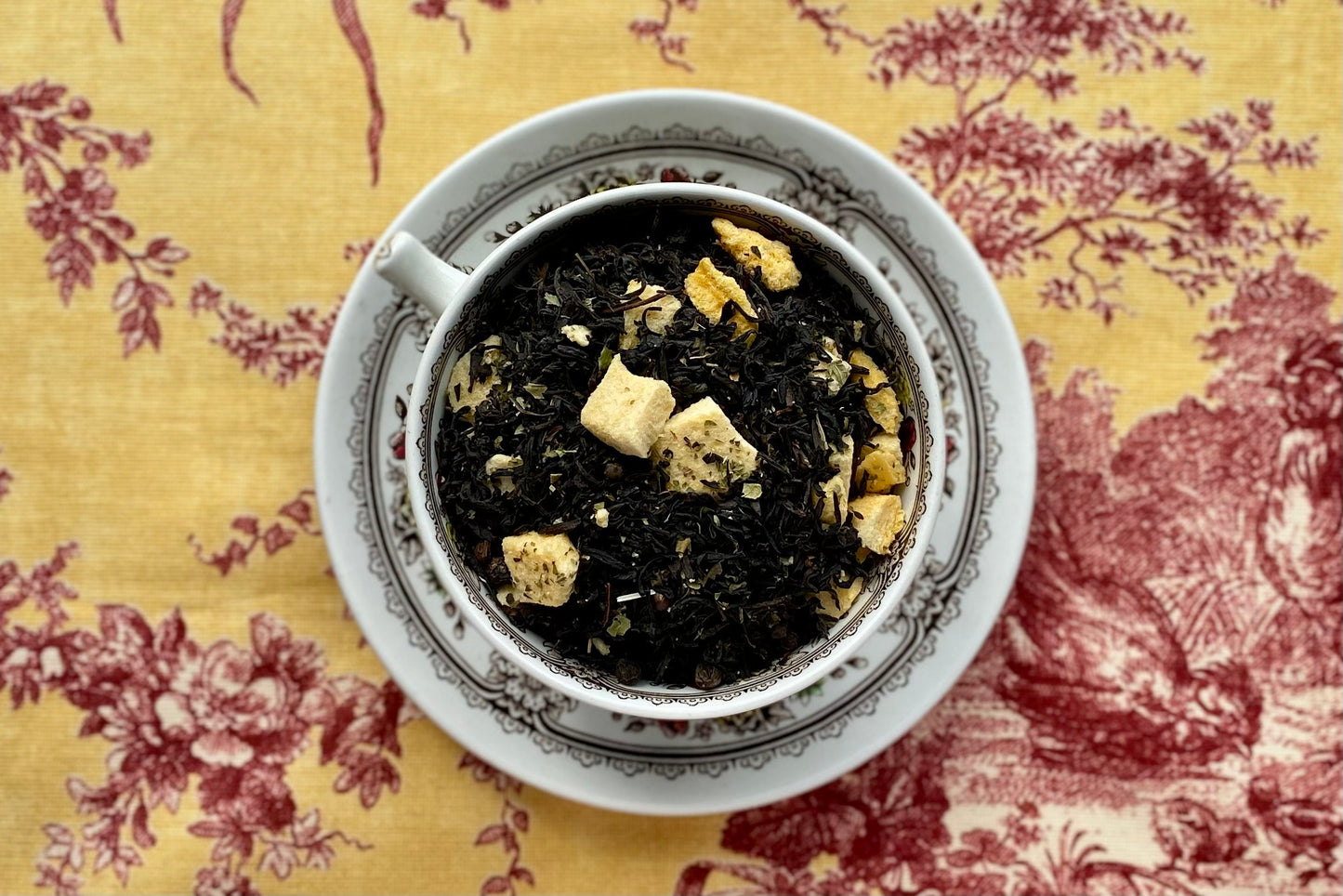 Teacup full of black tea and peaches