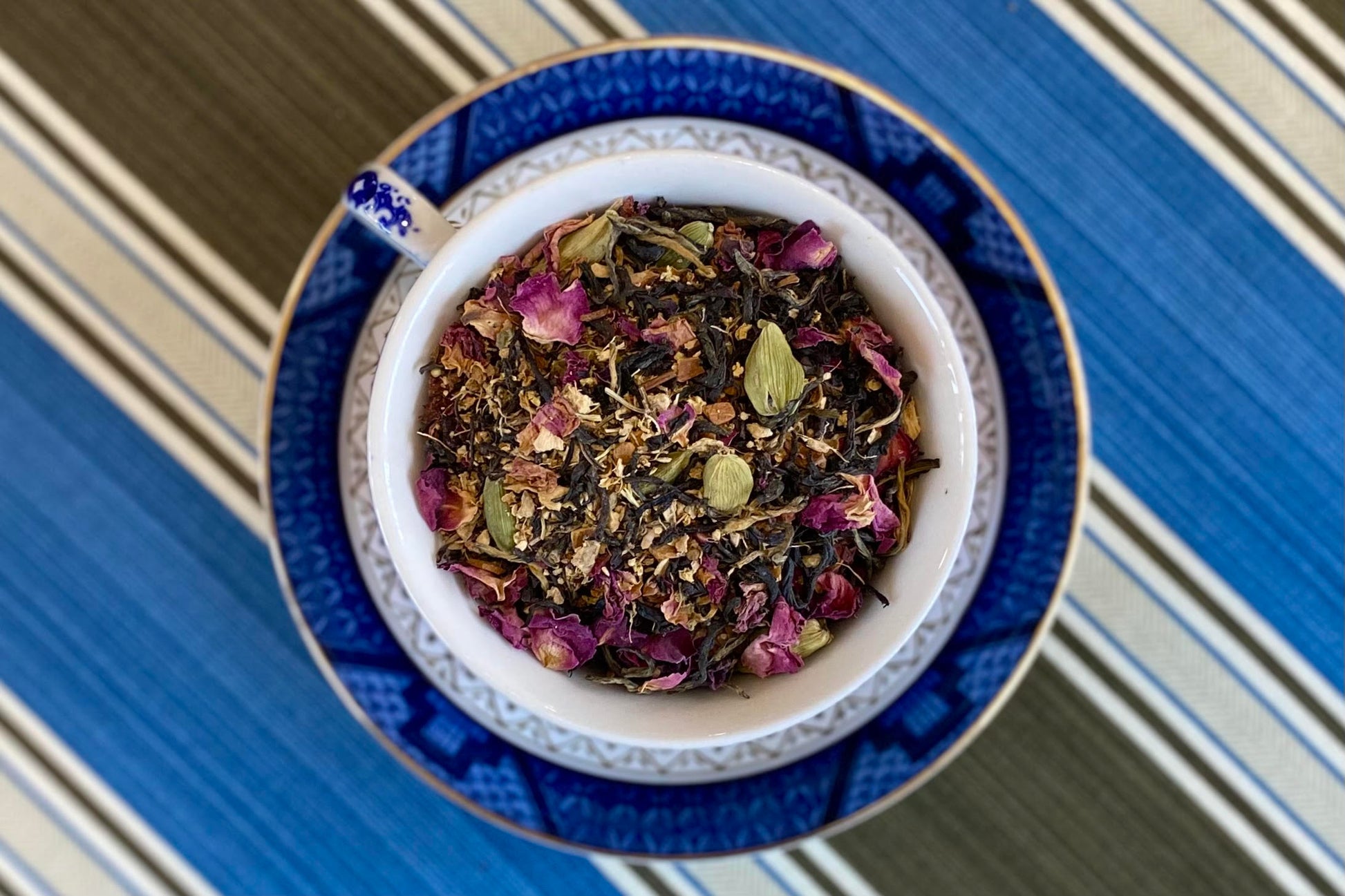 teacup full of black tea with cardamom and rose