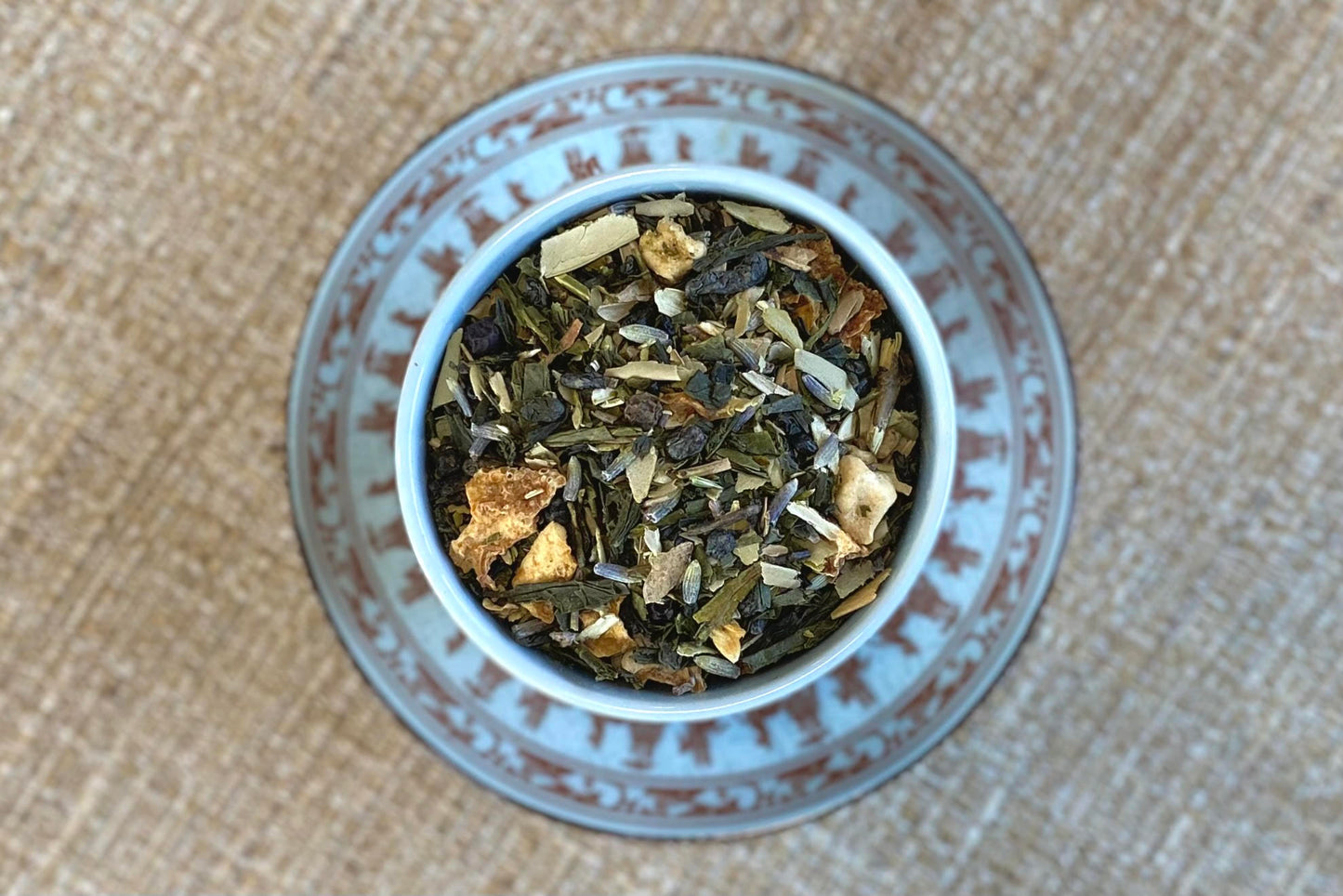 teacup full of green tea, lavender, olive leaf and citrus peel