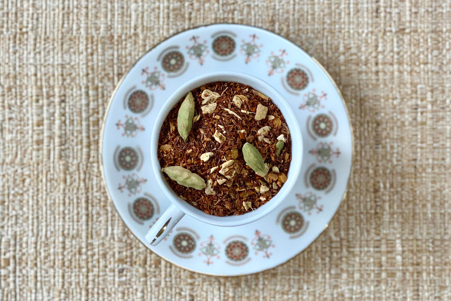 teacup full of rooibos red tea with cardamom and other spices