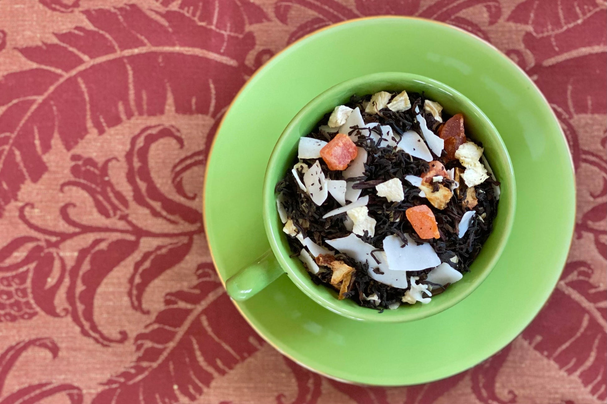 cup full of tropical fruit and black tea