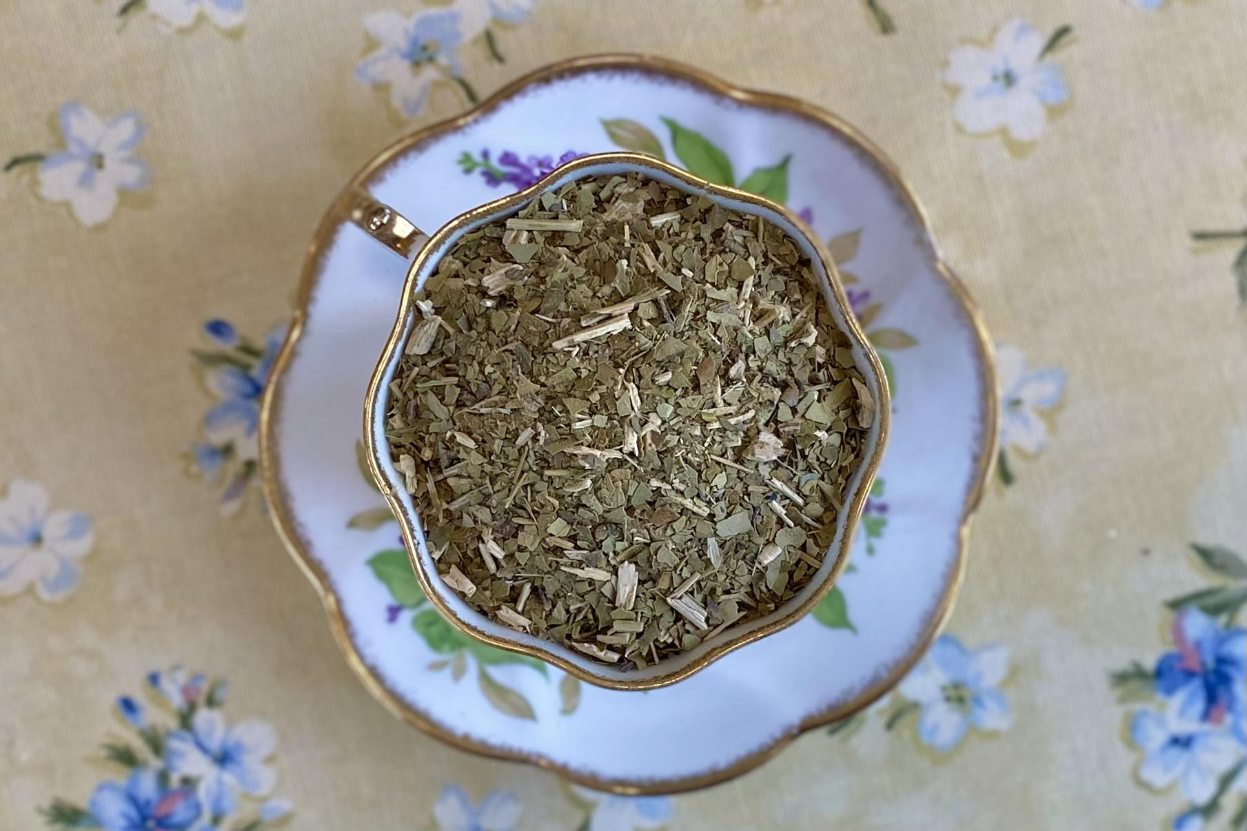 teacup full of cut green leaf