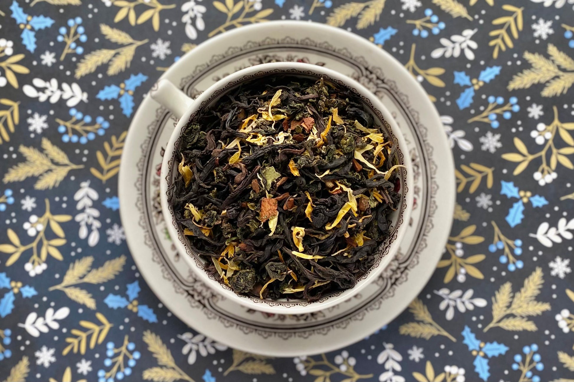 Teacup full of black tea, oolong and flowers