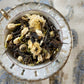 Teacup full of leaves and flowers