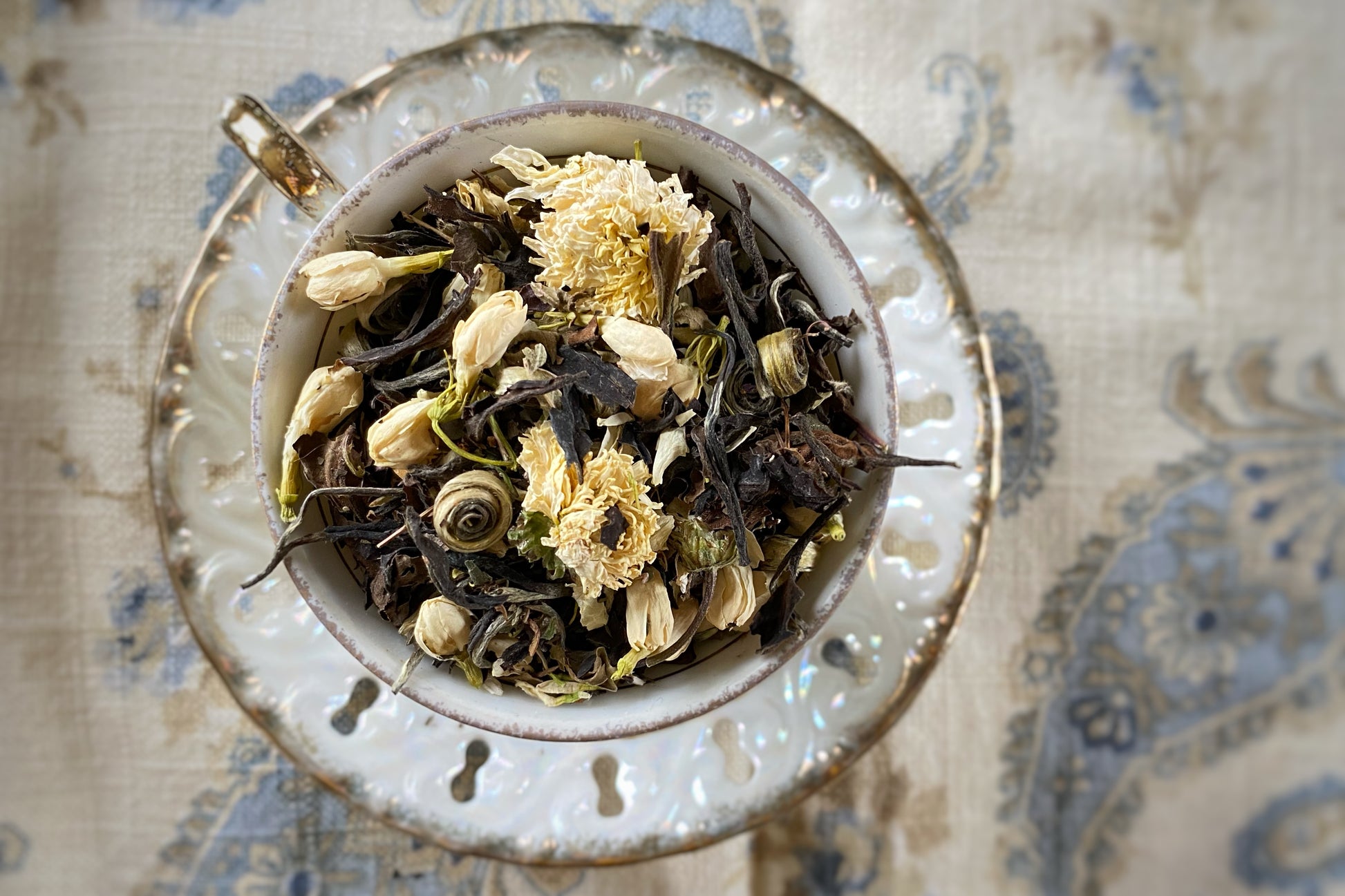 Teacup full of leaves and flowers